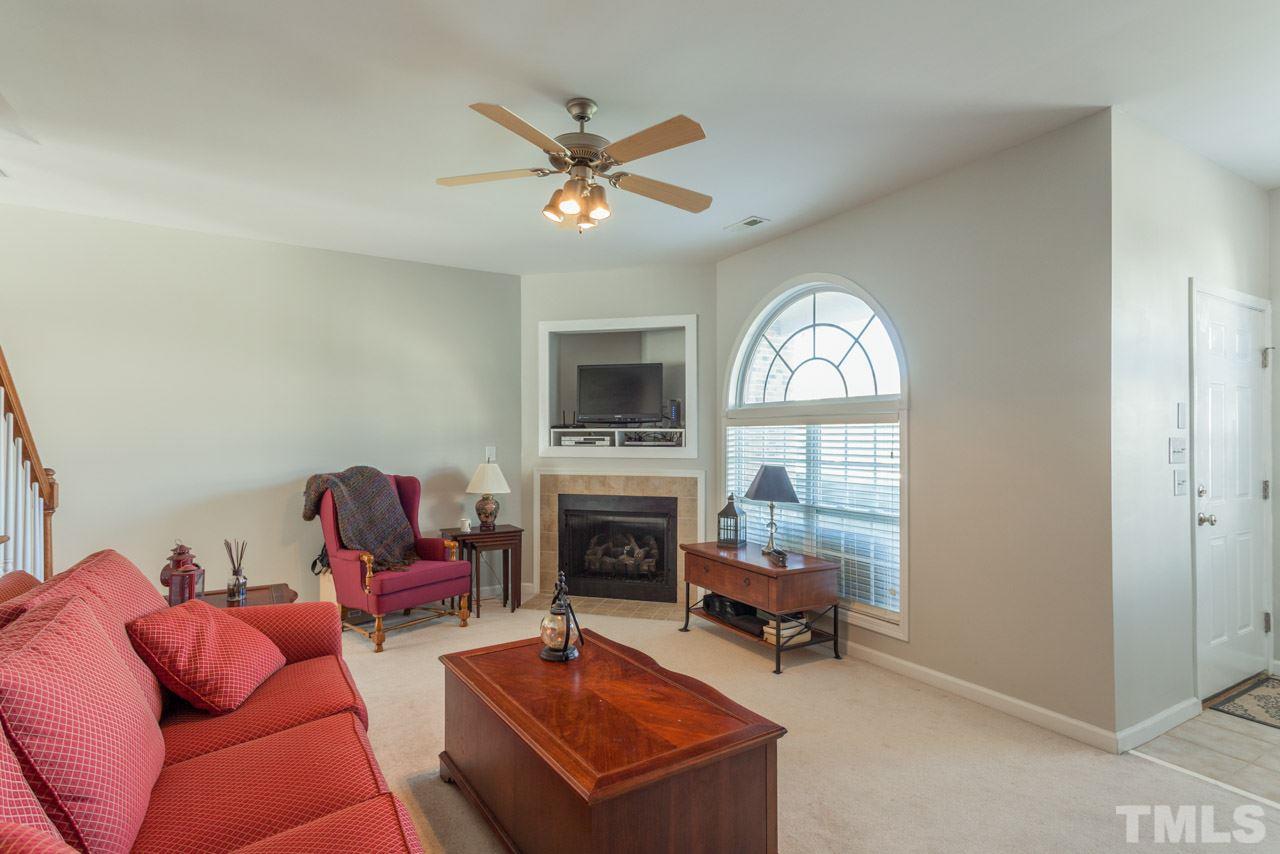 2120 Piney Brook Road, Unit 102 Raleigh, NC 27614 - Photo 6 of 24 a living room with furniture a fireplace and a flat screen tv