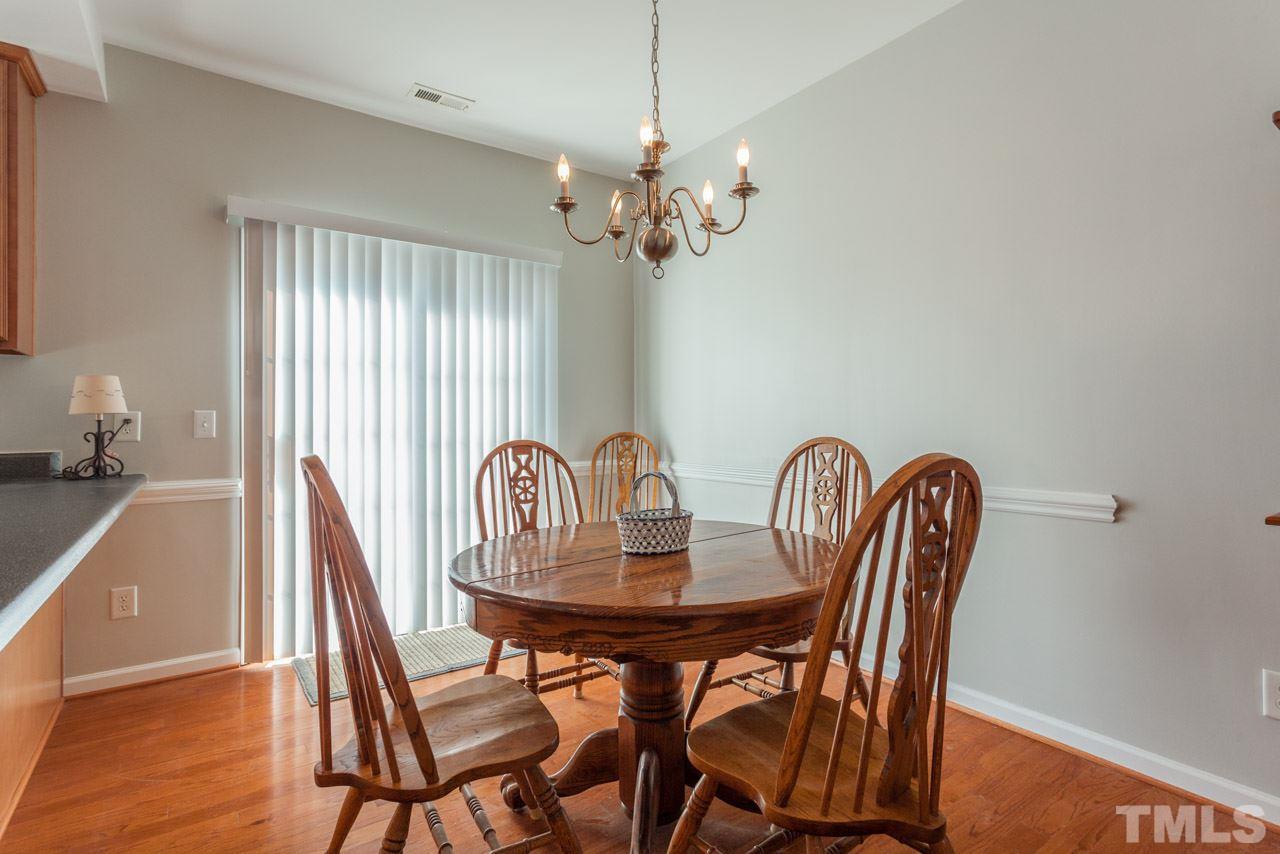 2120 Piney Brook Road, Unit 102 Raleigh, NC 27614 - Photo 10 of 24 a dining room with furniture and wooden floor
