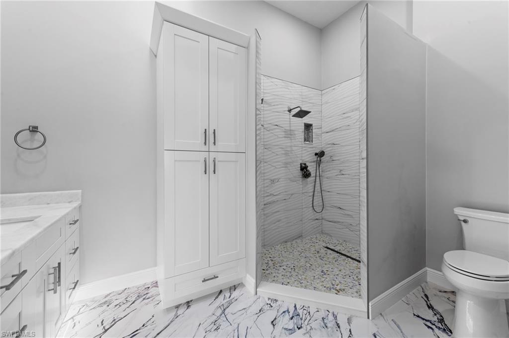 5720 Grande Reserve Way, Unit 2004 Naples, FL 34110 - Photo 13 of 27 a bathroom with a shower and toilet