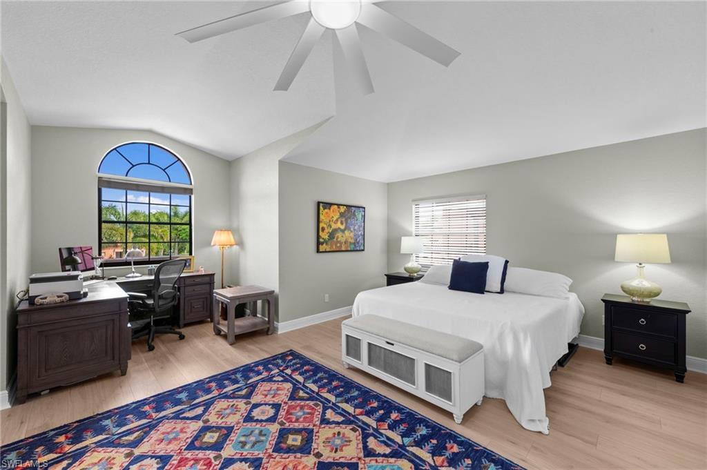 5720 Grande Reserve Way, Unit 2004 Naples, FL 34110 - Photo 14 of 27 a bedroom with a bed and a chandelier