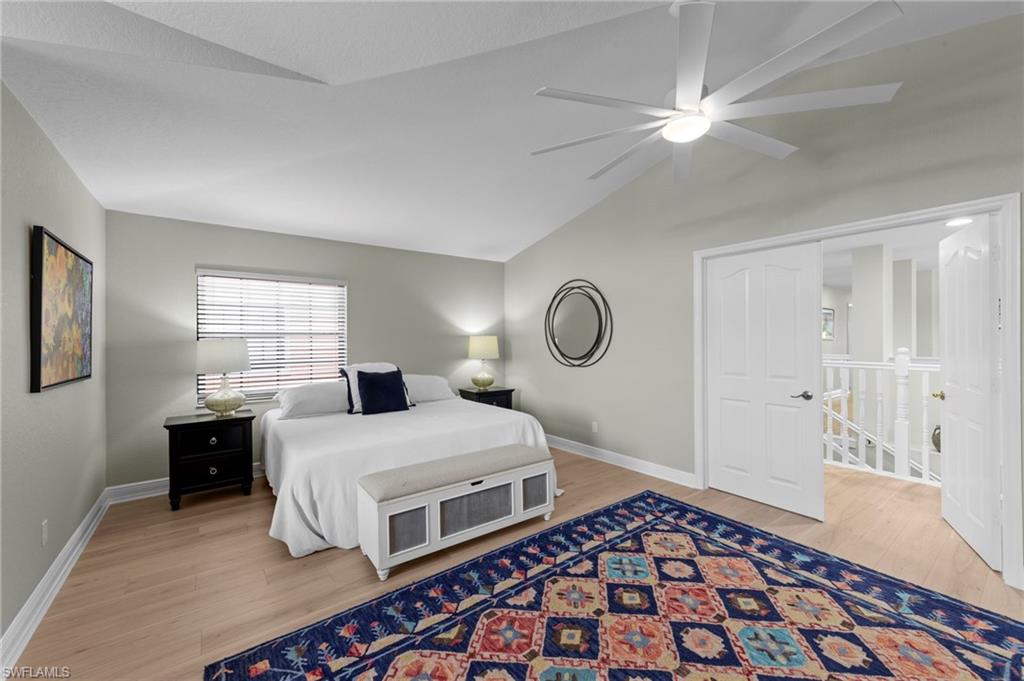 5720 Grande Reserve Way, Unit 2004 Naples, FL 34110 - Photo 15 of 27 a bedroom with a bed and wooden floor