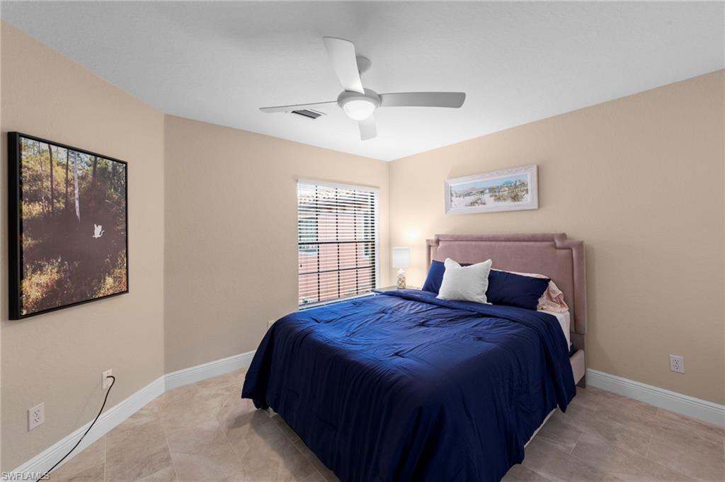 5720 Grande Reserve Way, Unit 2004 Naples, FL 34110 - Photo 17 of 27 a bedroom with a bed a painting on the wall and a window