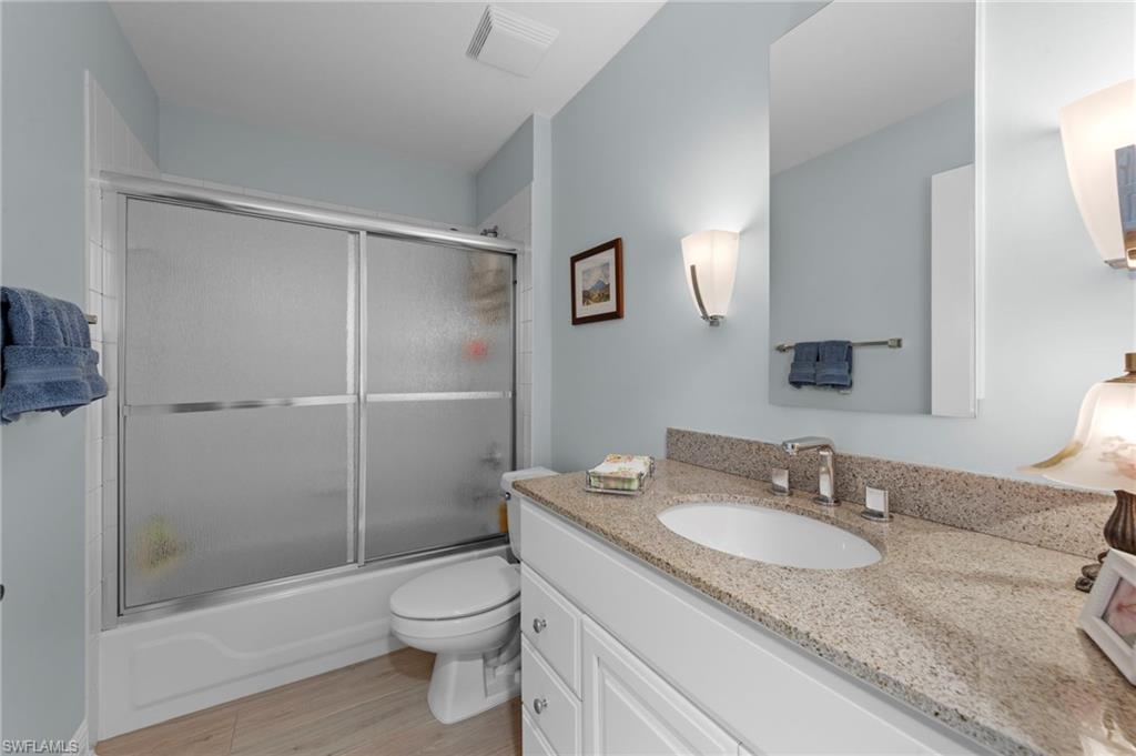 5720 Grande Reserve Way, Unit 2004 Naples, FL 34110 - Photo 18 of 27 a bathroom with a granite countertop sink toilet and shower