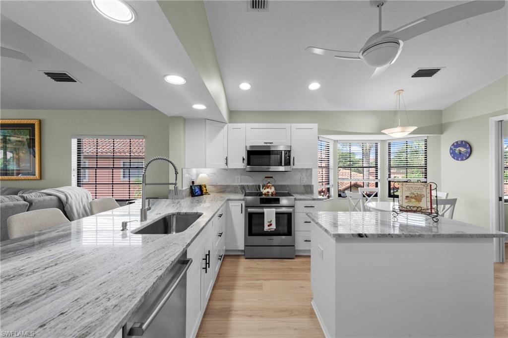 5720 Grande Reserve Way, Unit 2004 Naples, FL 34110 - Photo 6 of 27 a large kitchen with granite countertop lots of counter top space