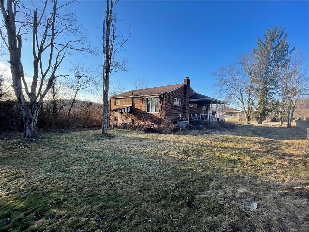104 Colbaugh Drive Trafford, PA 15085 - Photo 2 of 16 a house view with wooden fence and large trees