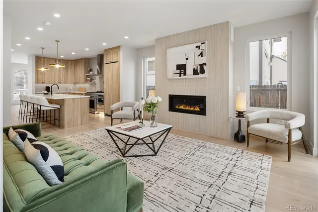 a living room with furniture a rug and a chandelier