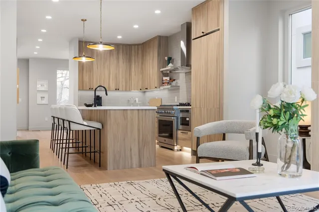 a living room with furniture and kitchen view