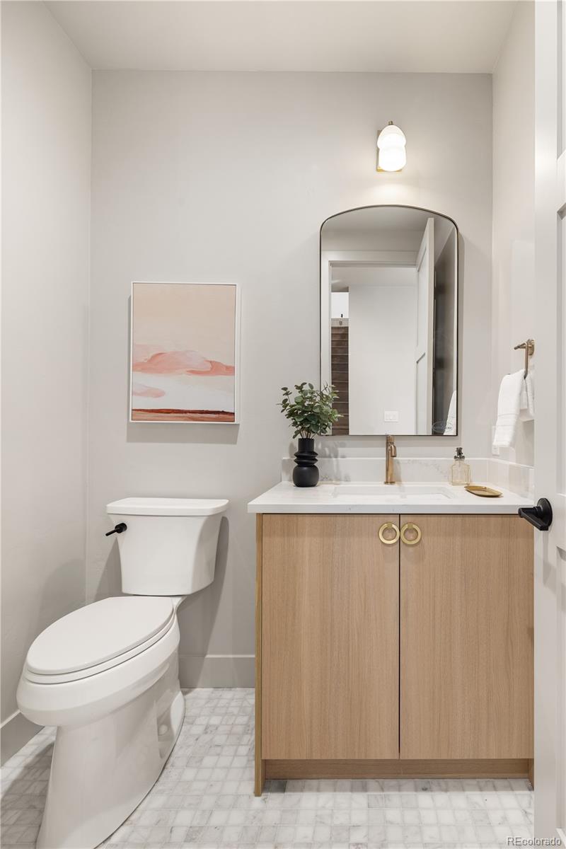 4572 North Raleigh Street Denver, CO 80212 - Photo 18 of 50 a bathroom with a toilet a sink and mirror