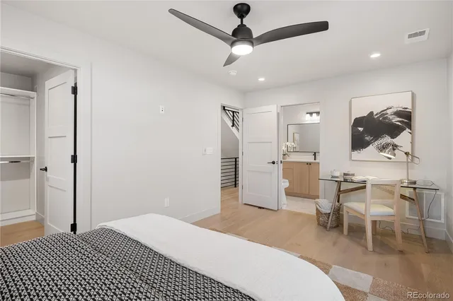 a view of a hallway with wooden floor and chair