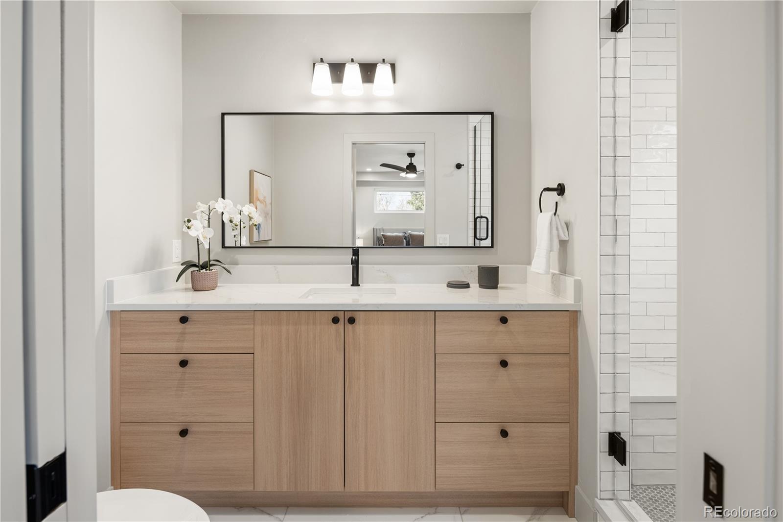 4572 North Raleigh Street Denver, CO 80212 - Photo 24 of 50 a bathroom with a double vanity sink and a mirror