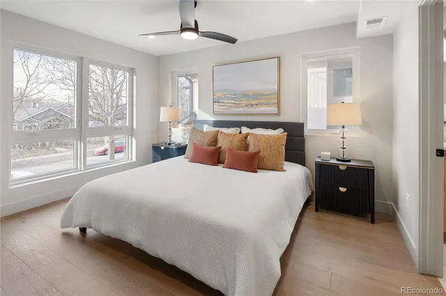 a bedroom with a large bed and a chandelier