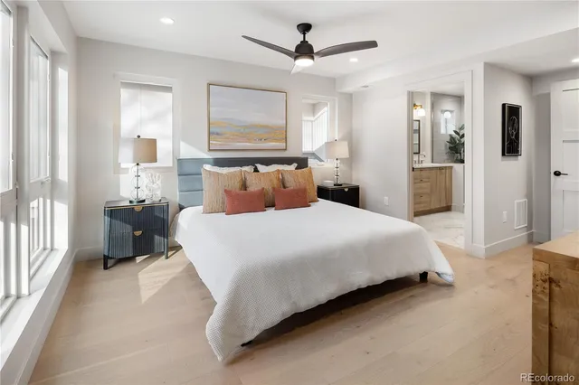 a bedroom with a bed and a painting on the wall