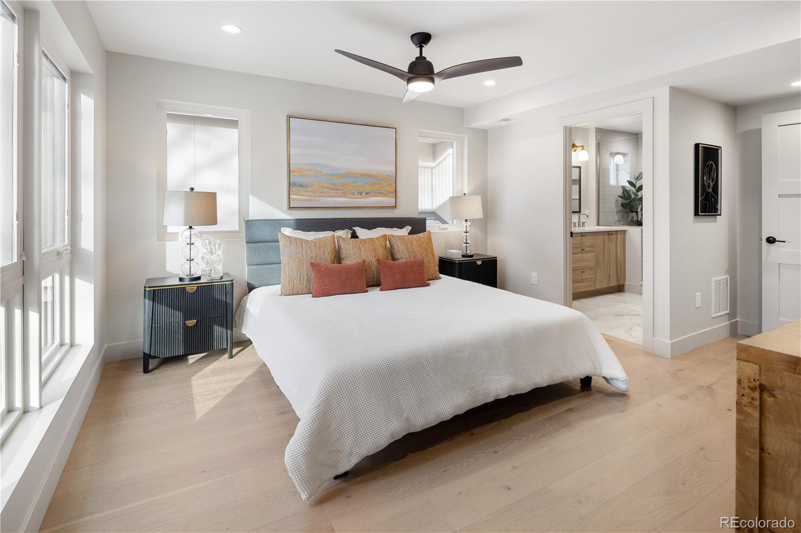 4572 North Raleigh Street Denver, CO 80212 - Photo 27 of 50 a bedroom with a large bed and a chandelier