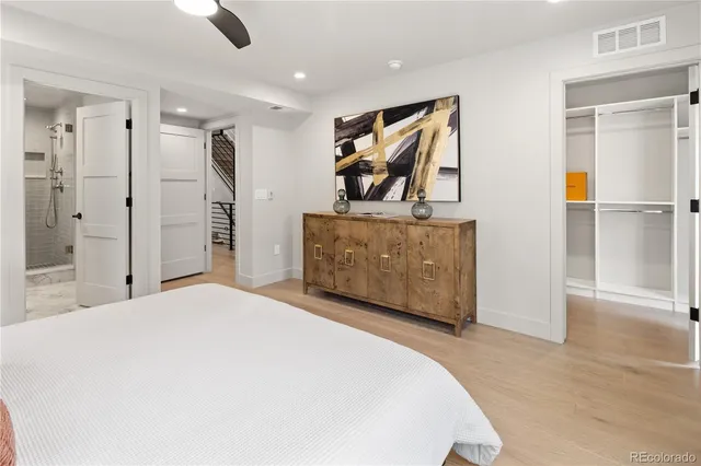 a bathroom with a granite countertop sink a toilet and shower