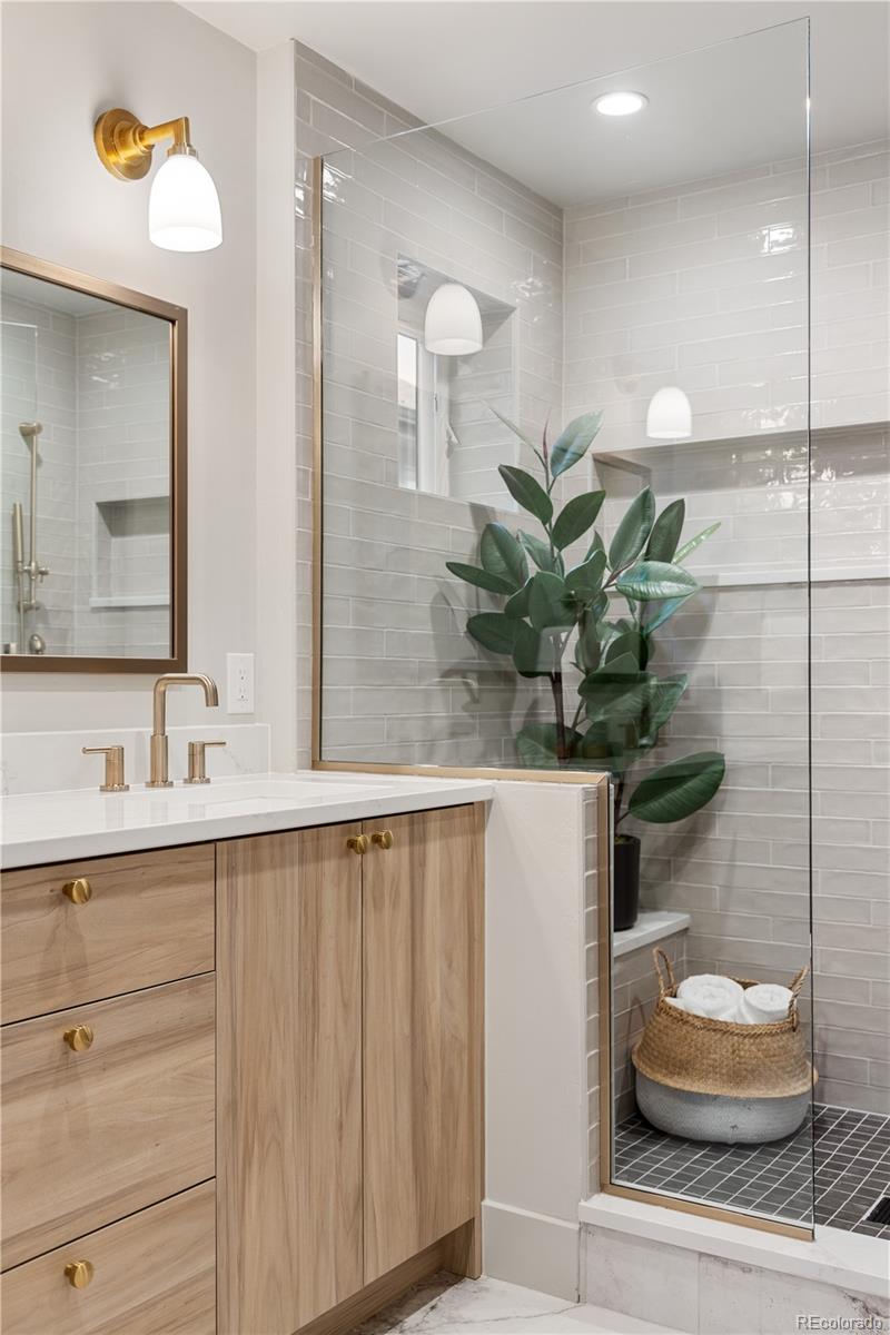 4572 North Raleigh Street Denver, CO 80212 - Photo 30 of 50 a bathroom with a sink a toilet and a mirror