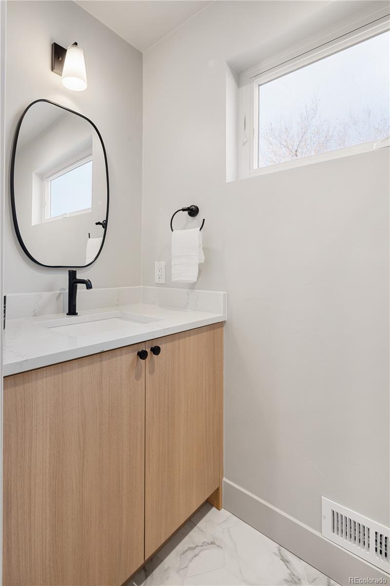 4572 North Raleigh Street Denver, CO 80212 - Photo 33 of 50 a bathroom with a sink and a mirror