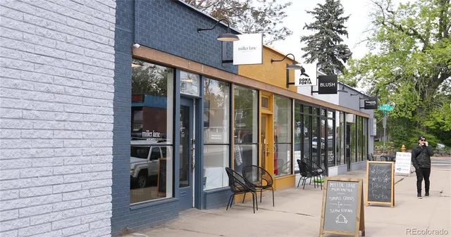 an aerial view of residential house with outdoor space and trees all around