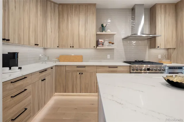 a kitchen with kitchen island granite countertop a sink stainless steel appliances and cabinets