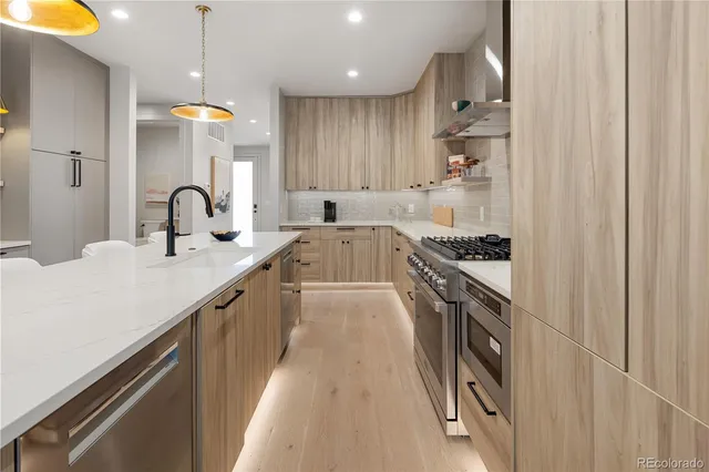 a kitchen with stainless steel appliances granite countertop a sink and cabinets