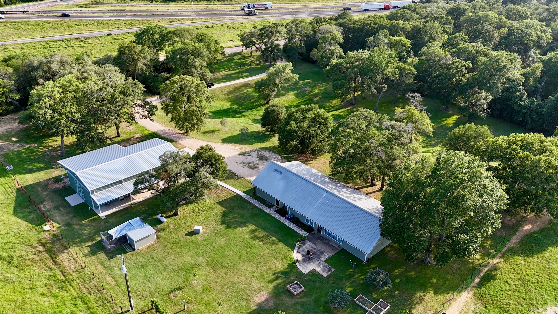 an aerial view of residential house with outdoor space and a swimming pool