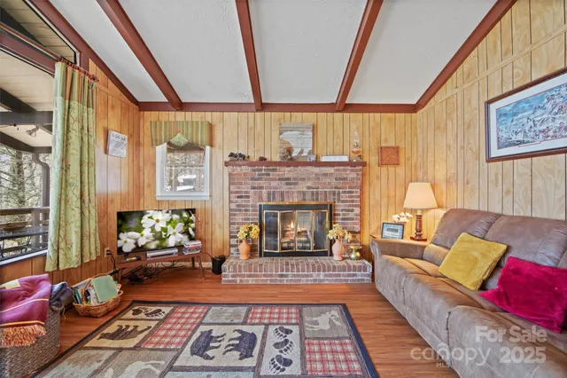 a bedroom with furniture and a large window