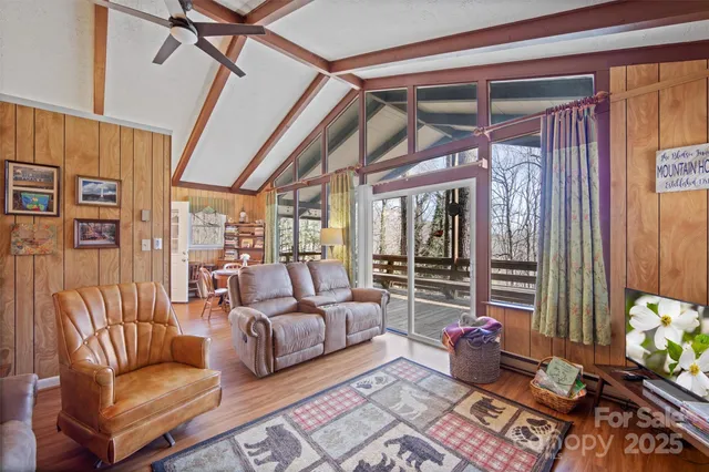 a living room with furniture fireplace and flat screen tv