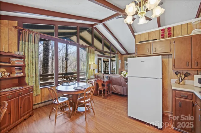 a dining room with furniture window and wooden floor