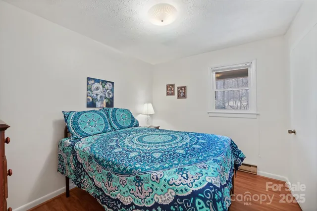 a bed room with a bed and a television