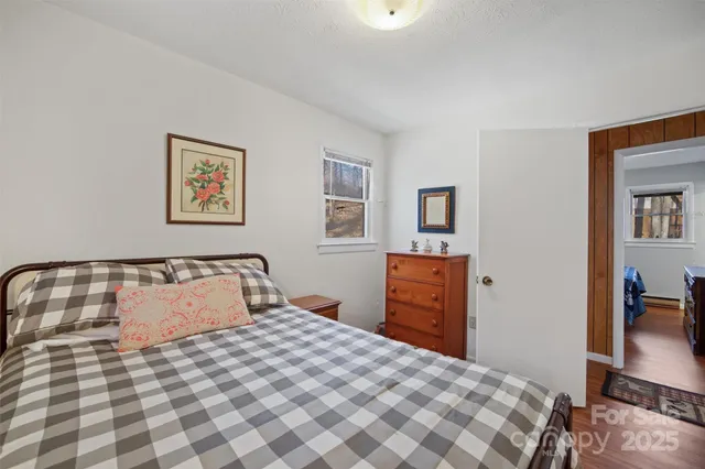 a bedroom with a bed and a lamp