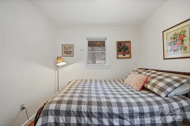 a bed room with a bed and a lamp