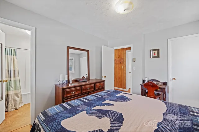 a bed room with furniture and a lamp