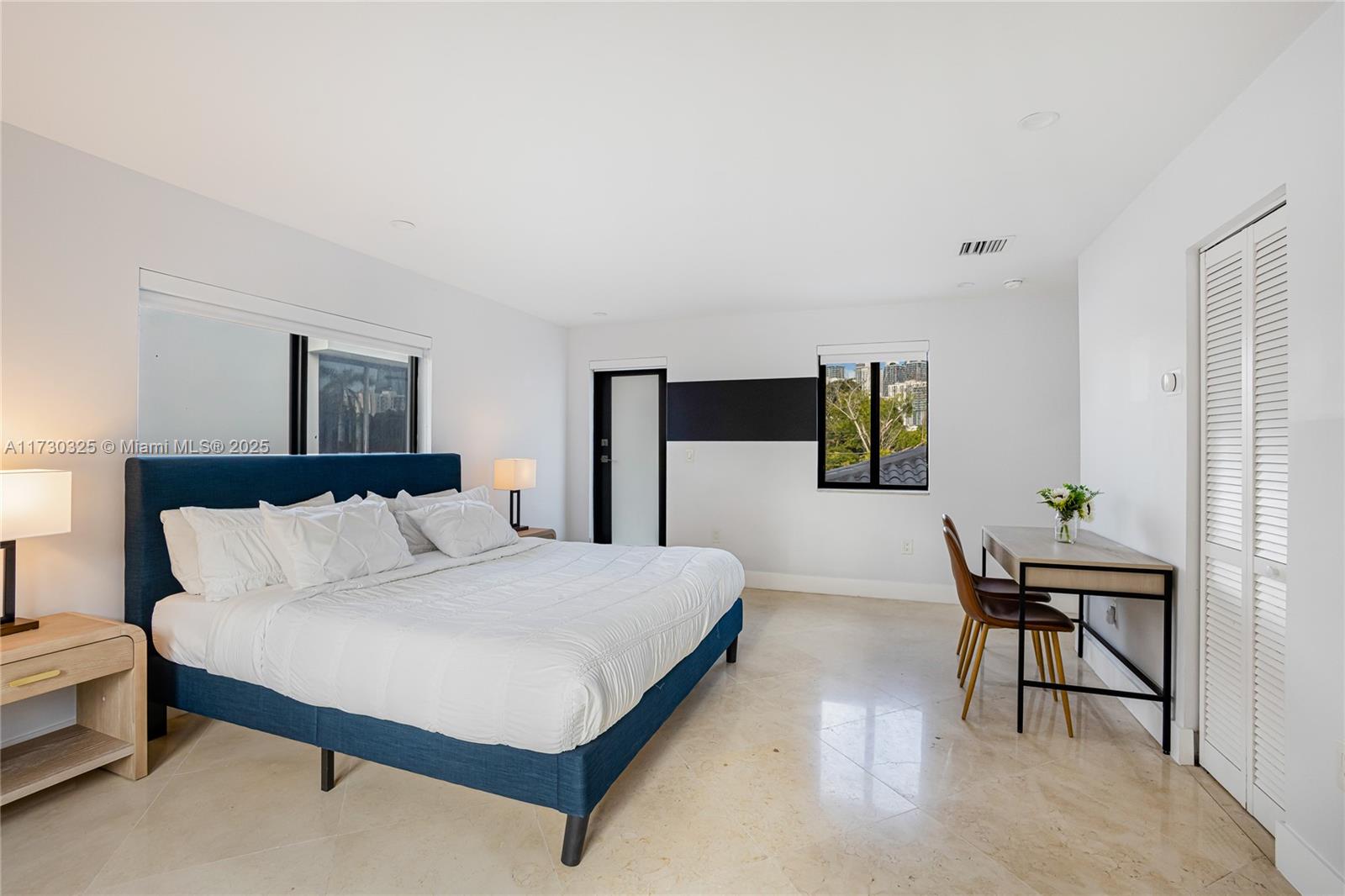 320 Southwest 19th Road Miami, FL 33129 - Photo 41 of 72 a bedroom with a bed and a table in it