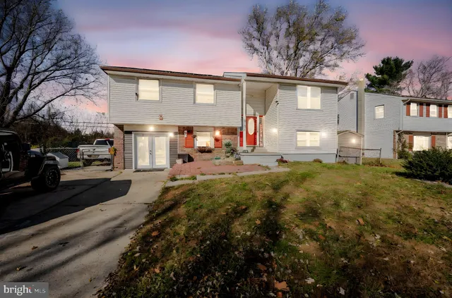 a front view of a house with a yard and a garage