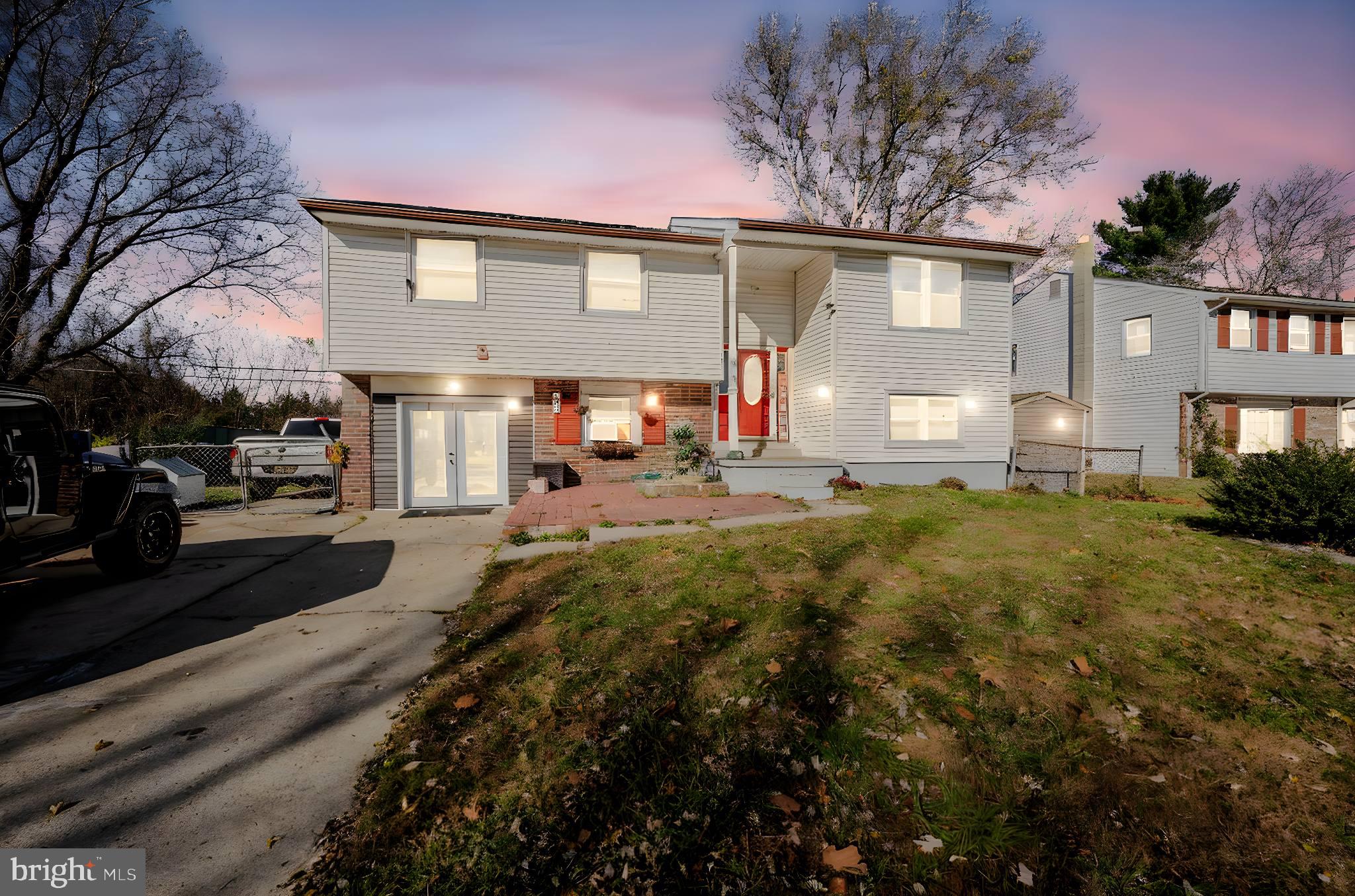 a front view of a house with a yard and a garage