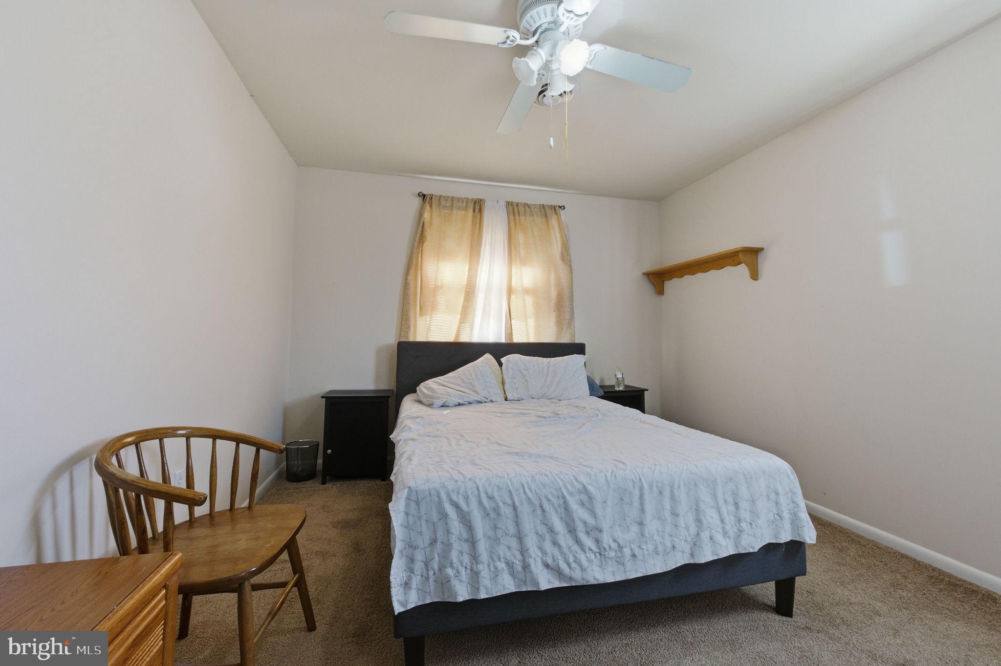 809 Bacon Avenue Dover, DE 19901 - Photo 11 of 27 a bedroom with a bed and a chandelier