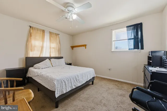 a bedroom with a bed wooden floor and a window