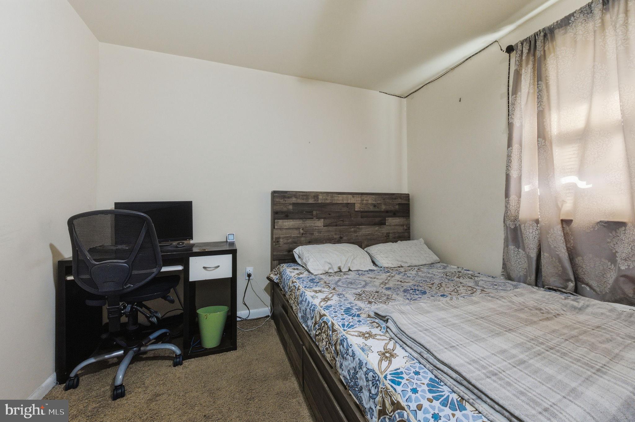 809 Bacon Avenue Dover, DE 19901 - Photo 16 of 27 a bedroom with a bed a desk and chair