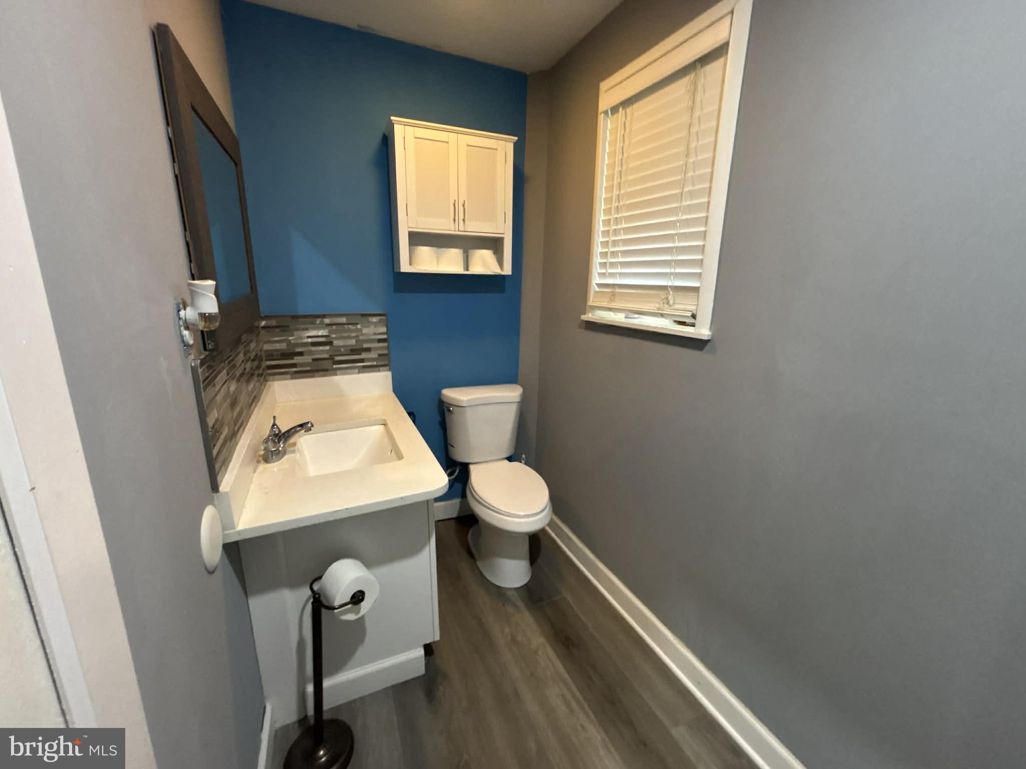 809 Bacon Avenue Dover, DE 19901 - Photo 21 of 27 a bathroom with a toilet a sink and a window