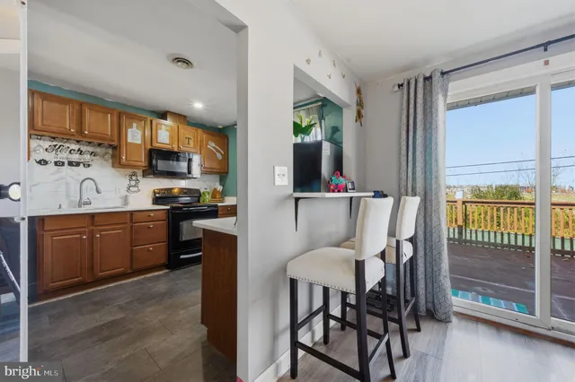 a kitchen with a table chairs refrigerator and cabinets