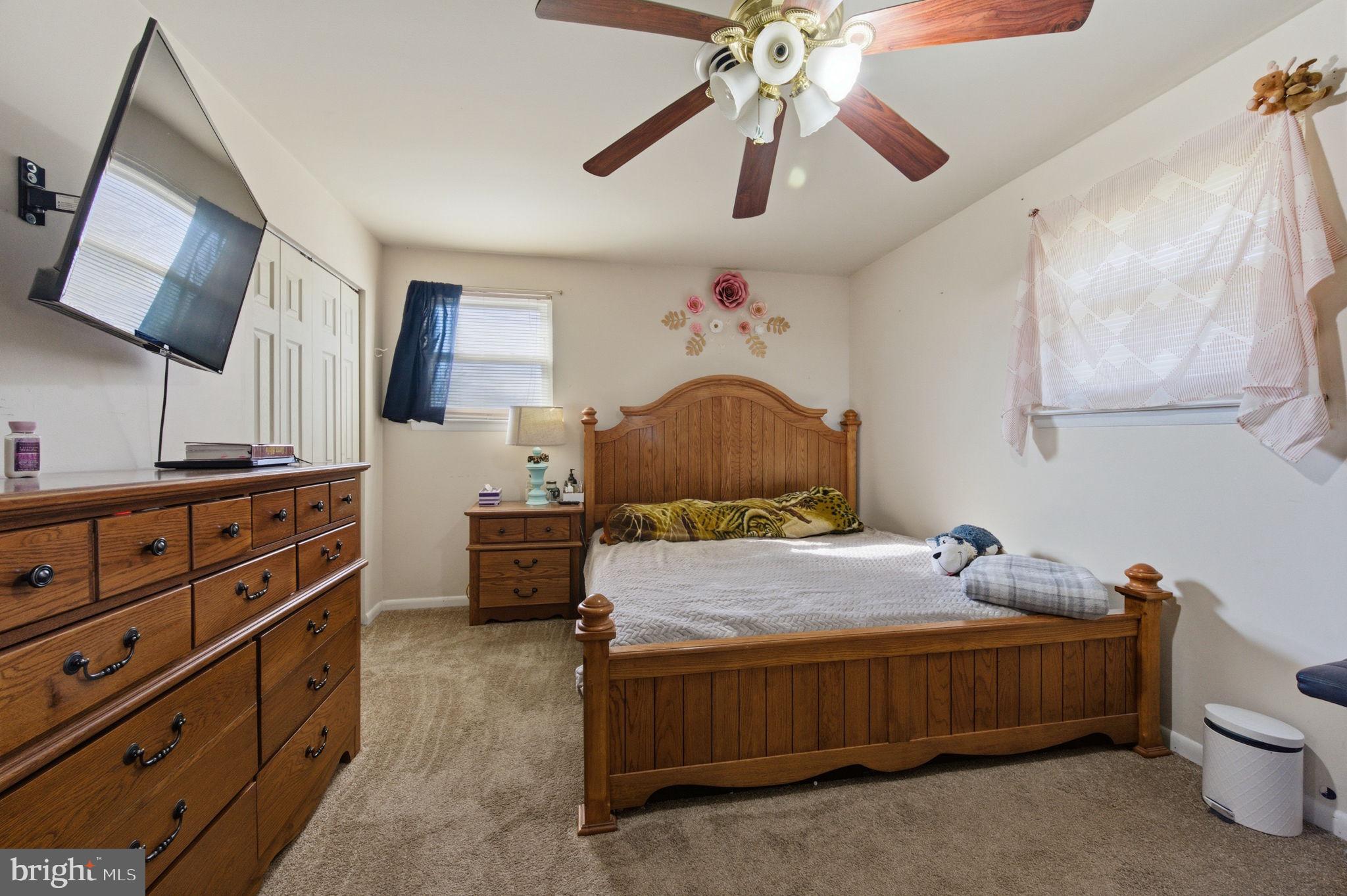 809 Bacon Avenue Dover, DE 19901 - Photo 10 of 27 a bedroom with a bed and a chandelier