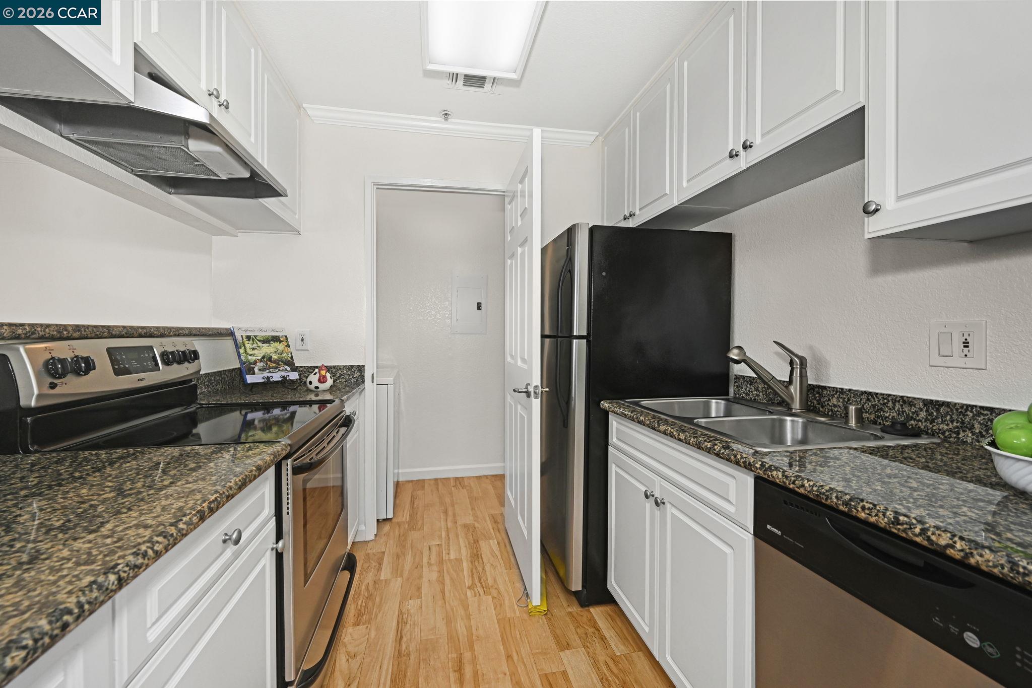 440 Bollinger Canyon Lane, Unit 396 San Ramon, CA 94582 - Photo 12 of 24 a kitchen with stainless steel appliances granite countertop a sink stove and refrigerator
