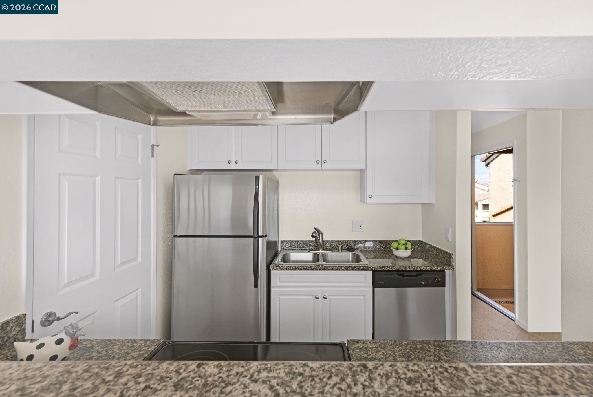 440 Bollinger Canyon Lane, Unit 396 San Ramon, CA 94582 - Photo 13 of 24 a kitchen with a refrigerator and a sink