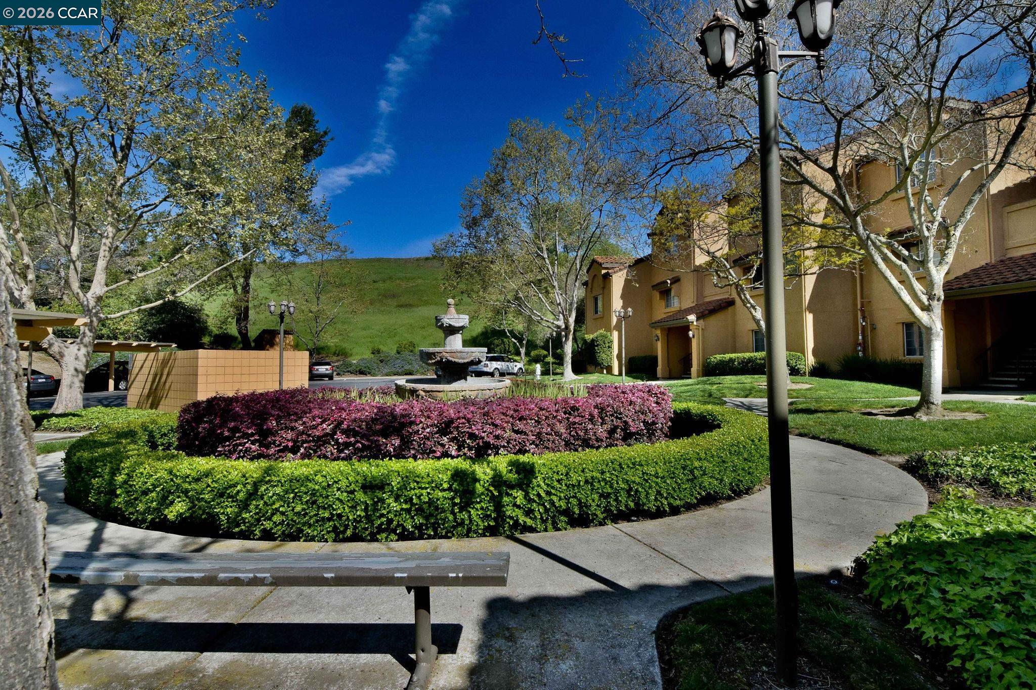 440 Bollinger Canyon Lane, Unit 396 San Ramon, CA 94582 - Photo 22 of 24 a view of a garden with a bench in a garden