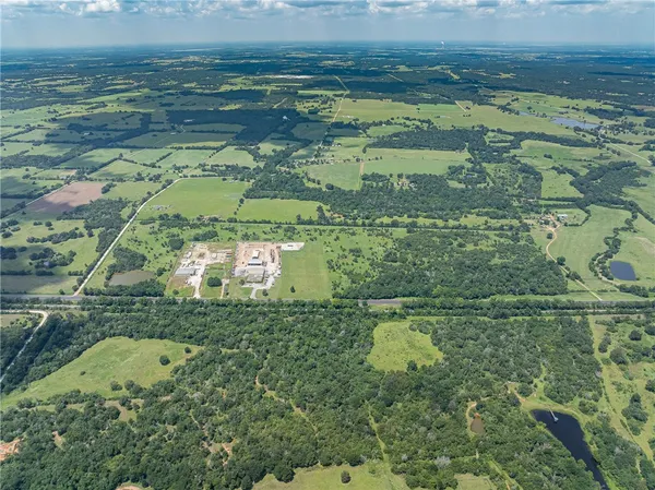 an aerial view of a residential houses with outdoor space