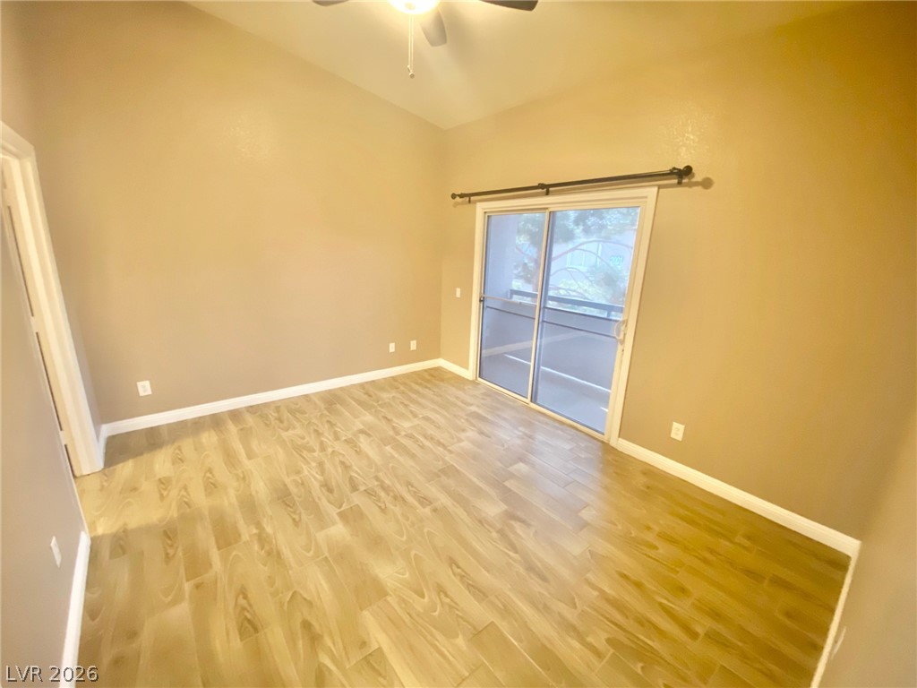 2000 Turquoise Ridge Street, Unit 204 Las Vegas, NV 89117 - Photo 26 of 29 A well-proportioned bedroom with attractive wood flooring and convenient sliding door access to outdoor space.