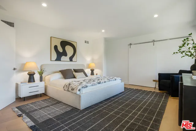 a bedroom with a large bed and a large window