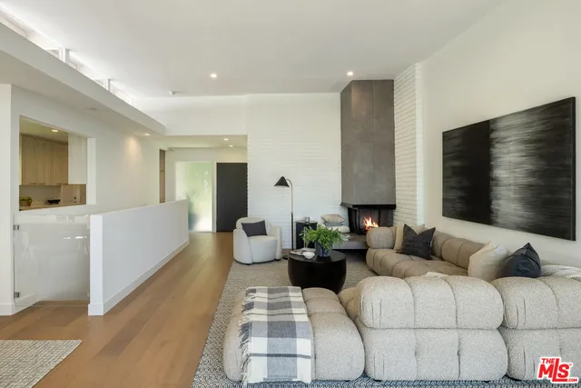 a living room with fireplace furniture and a flat screen tv