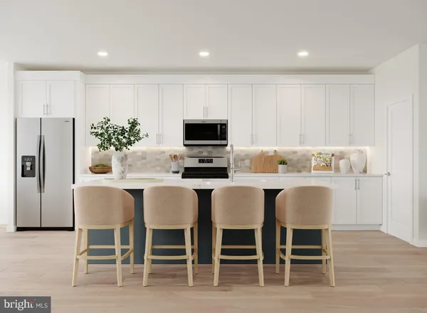 a kitchen with a dining table chairs and refrigerator