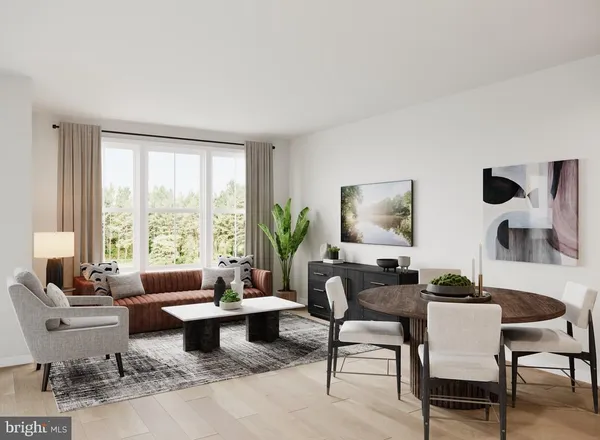 a living room with furniture and floor to ceiling windows