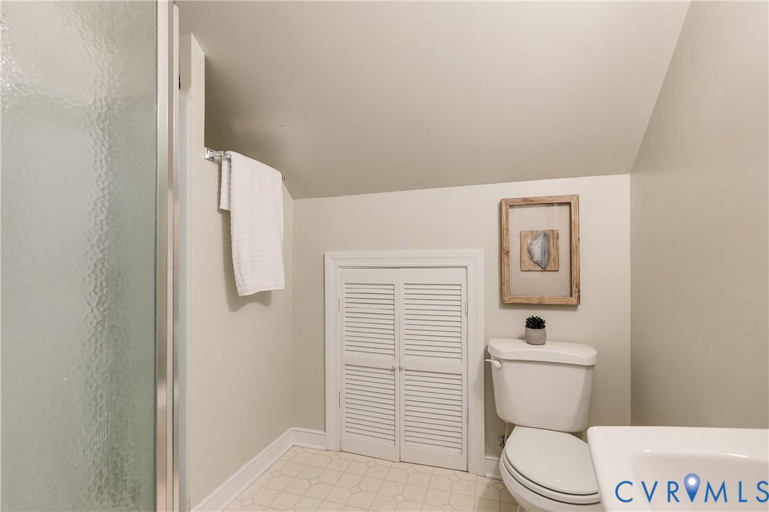 509 Wadeward Road Henrico, VA 23229 - Photo 54 of 59 a white toilet sitting next to a bathroom sink and vanity